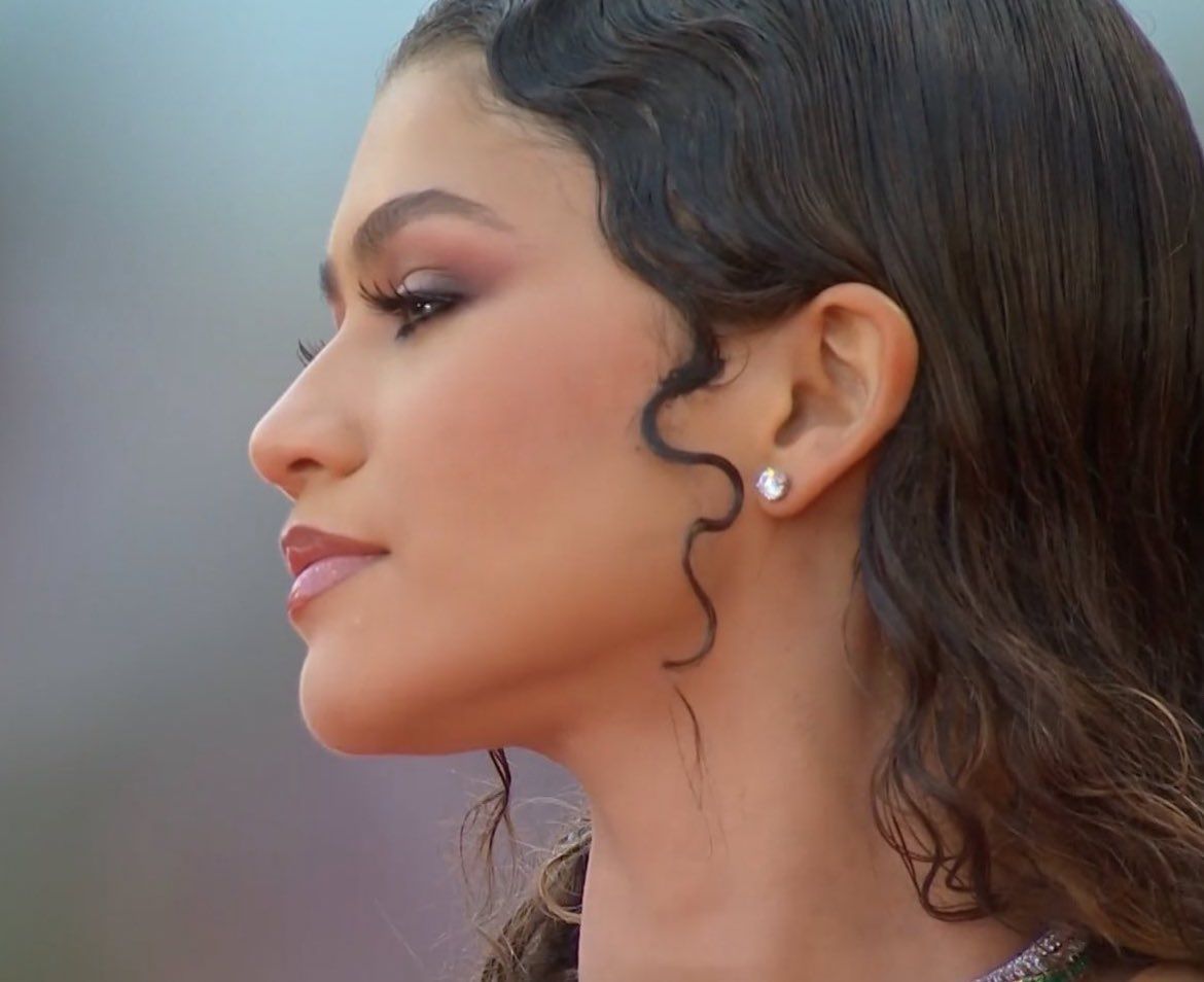 Close-up of Zendaya wearing a sparkling stud earring, illustrating how a stud sits on the earlobe; the backing is not visible and this is not Suzy Levian jewelry