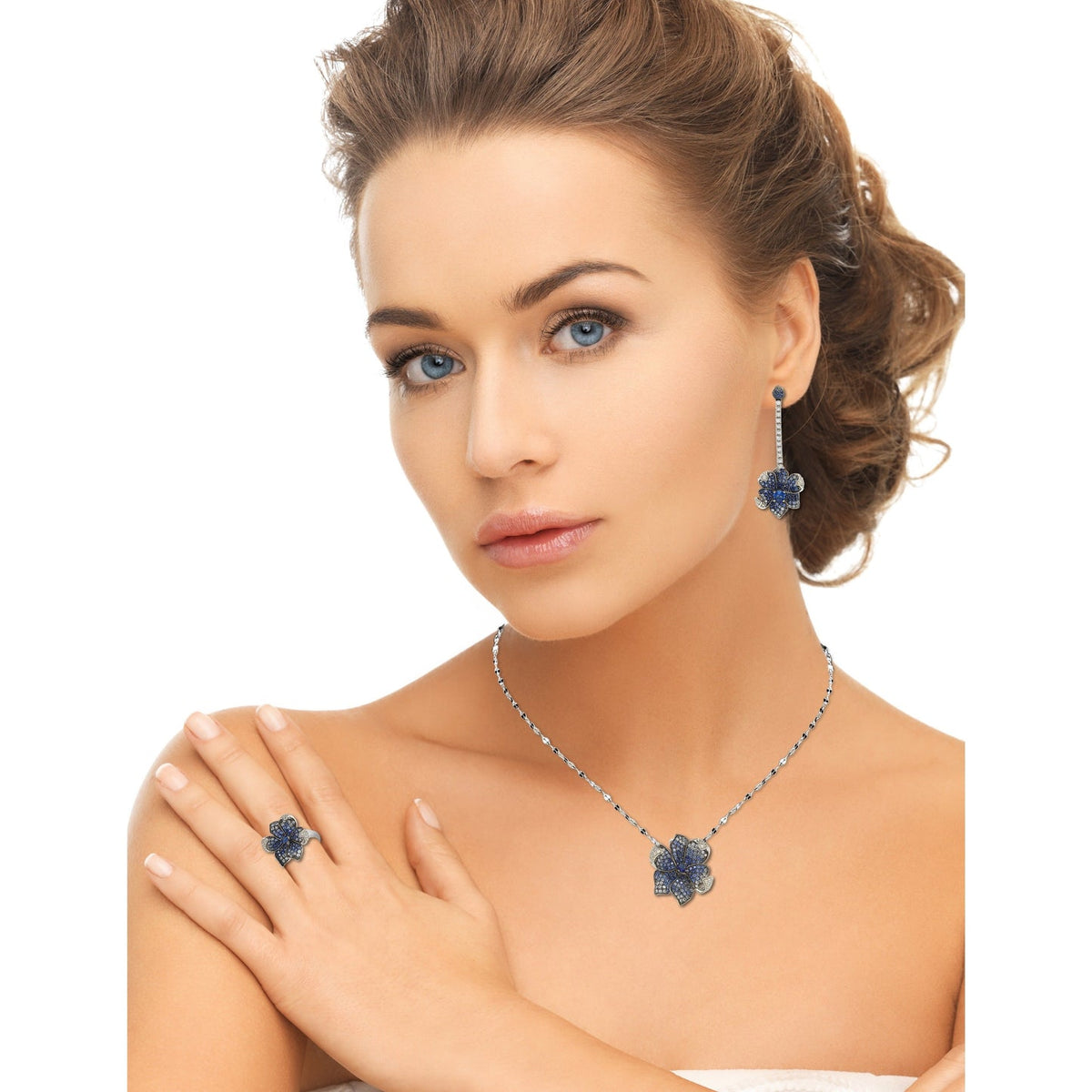 Model wearing Suzy Levian blue sapphire flower necklace and matching sterling silver jewelry