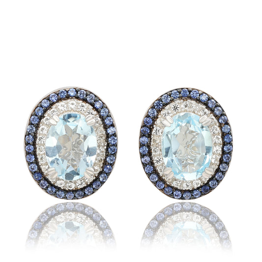 Suzy Levian Sterling Silver Oval Cut Blue Topaz And Sapphire Accent Stud Earrings